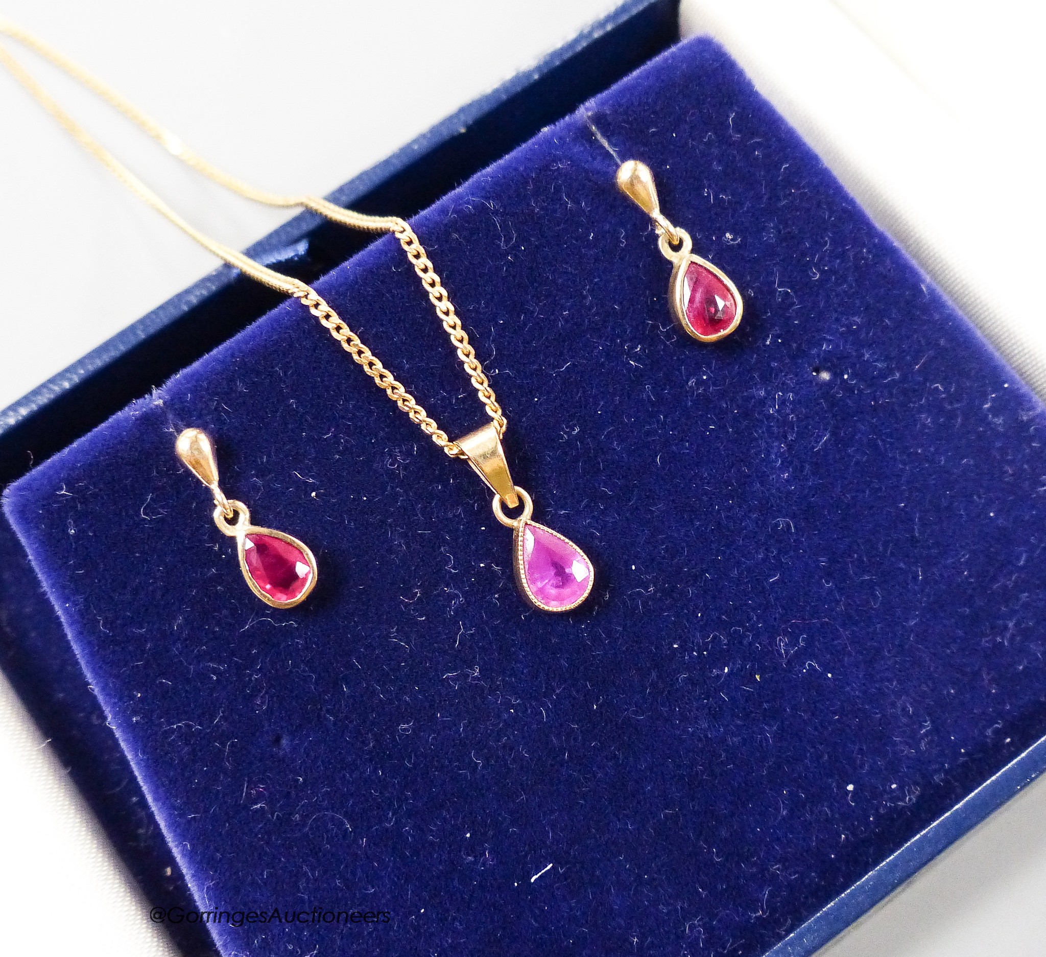 A modern 375 and ruby set drop pendant necklace, 46cm and pair of similar ear studs